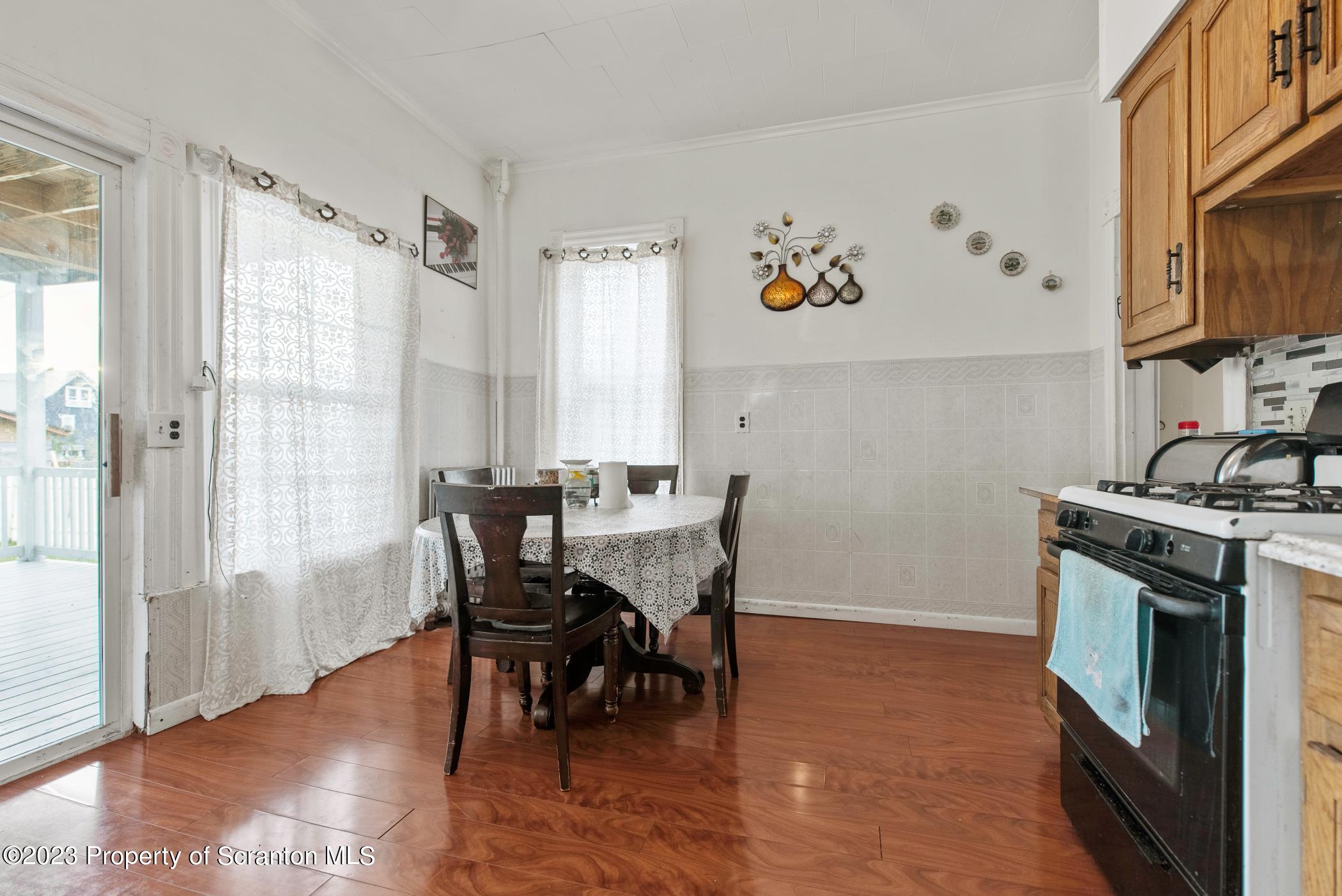 726 Hickory Street Scranton, PA 18505 - Photo 10 of 26 a view of a dining room with furniture window and wooden floor