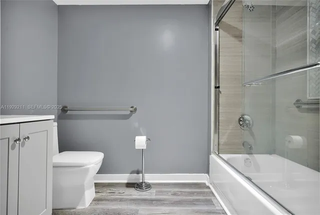 a bathroom with a sink a toilet a bathtub and shower