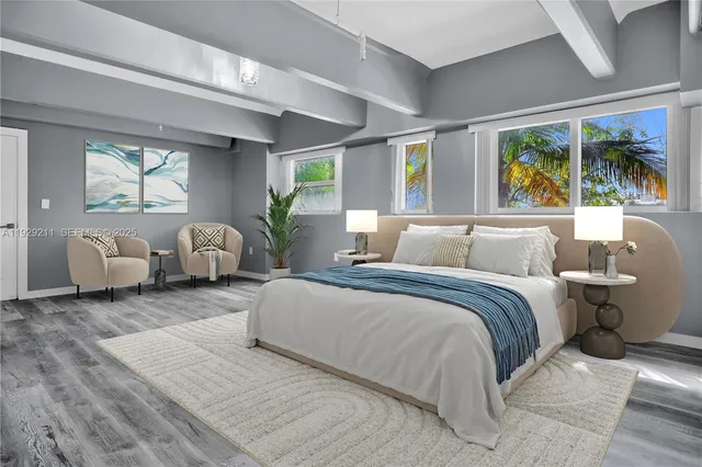 a spacious bedroom with a large bed and a large window