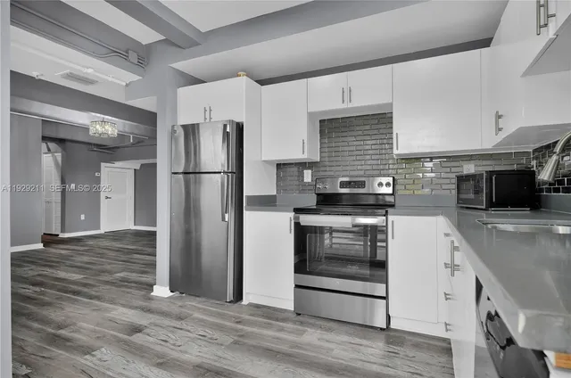 a kitchen with a refrigerator stove and sink