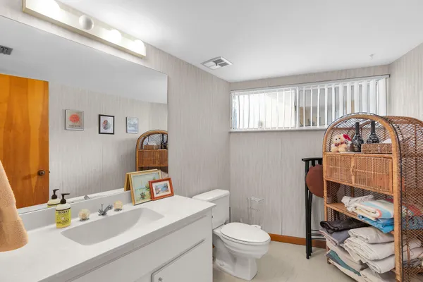 a bathroom with a sink toilet and a mirror