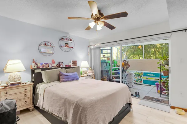 a bedroom with a bed and a large window