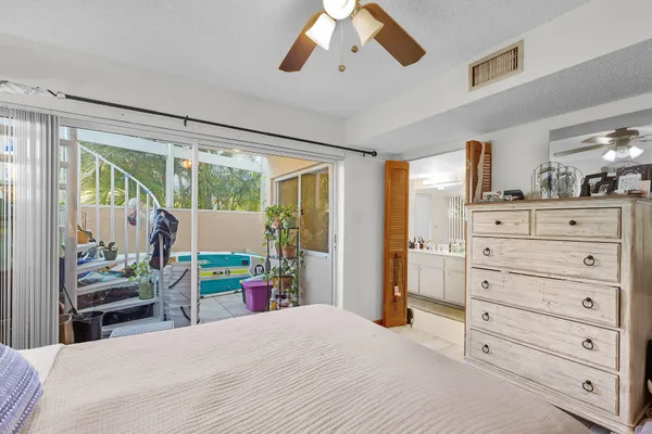 a bedroom with a bed and large mirror