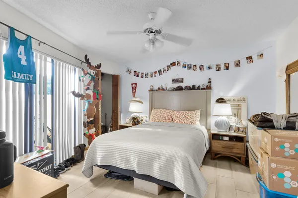 a bedroom with a bed couch and a window