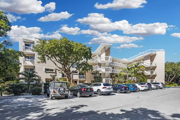 a view of a city with lots of residential buildings ocean and mountain view in back