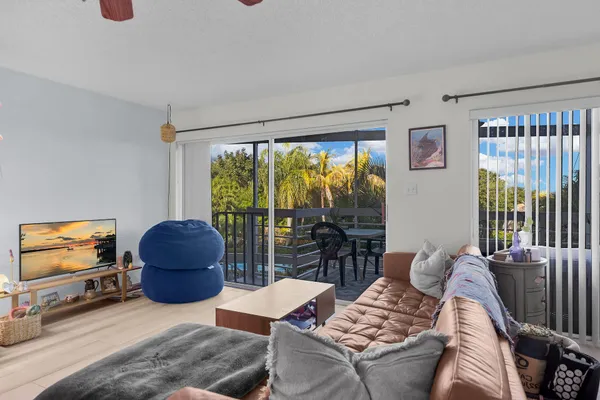 a living room with furniture and a floor to ceiling window