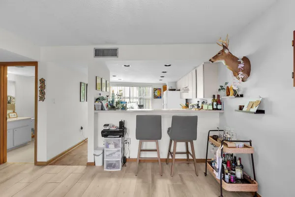 a view of kitchen with furniture and wooden floor