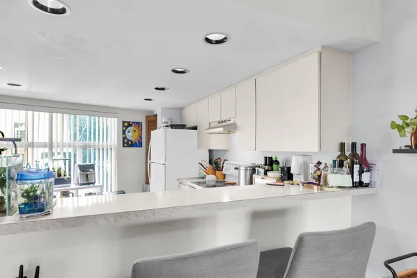 a kitchen with stainless steel appliances sink refrigerator and microwave