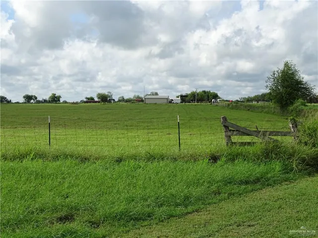 a view of a big yard with a barn