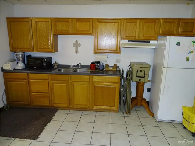 a kitchen with sink cabinets and utility room