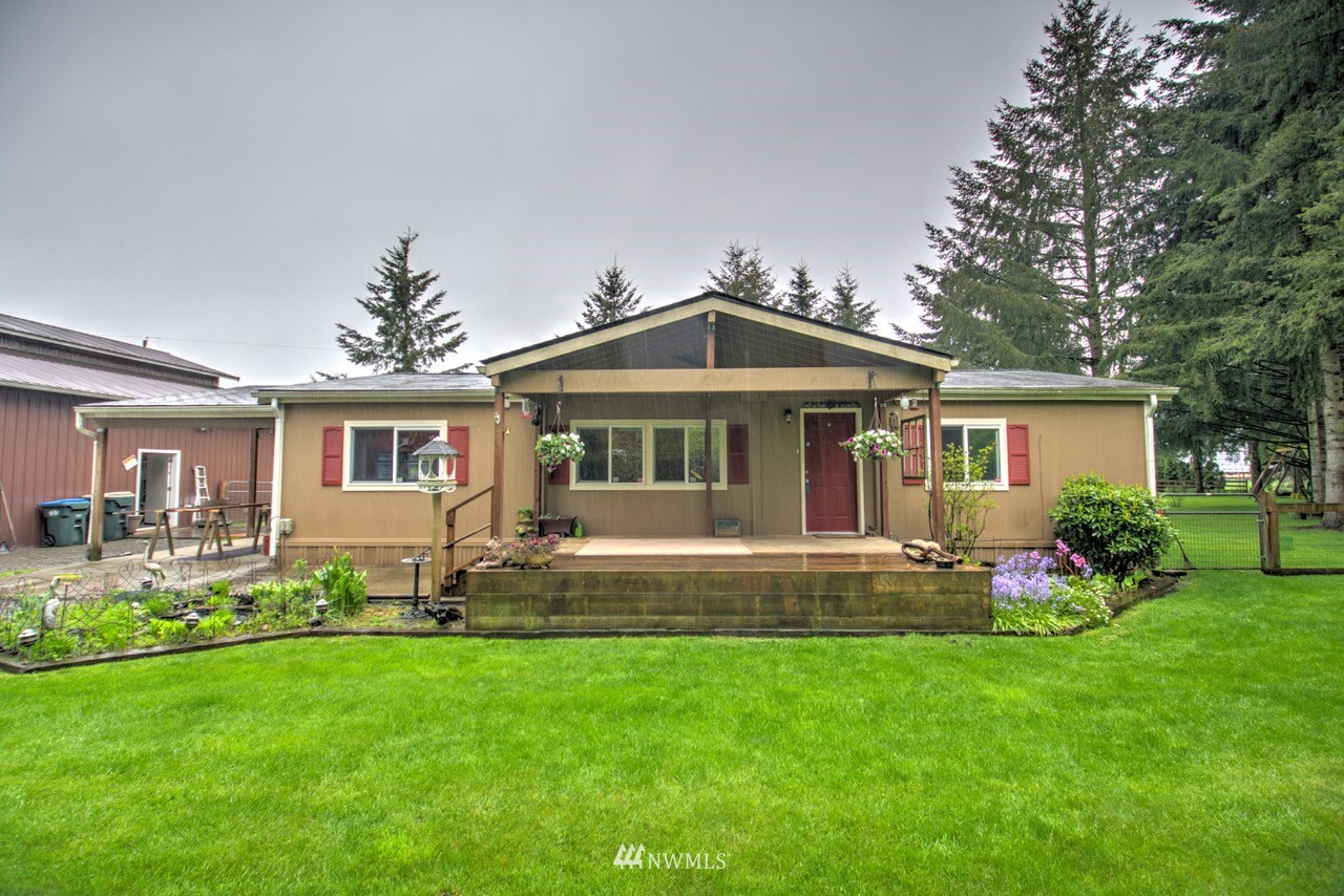 18101 Canaday Lane Southwest Rochester, WA 98579 - Photo 1 of 32 a front view of a house with a yard and trees