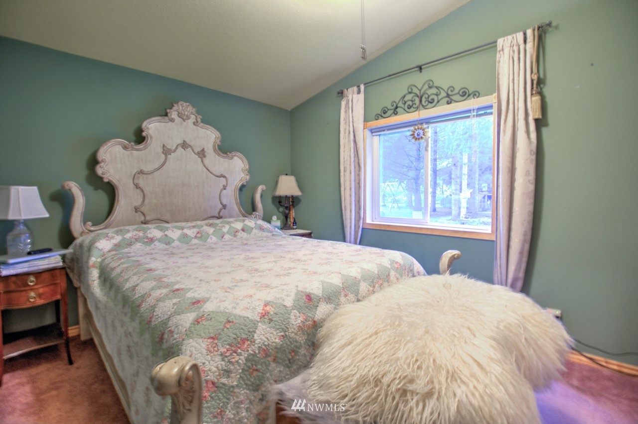 18101 Canaday Lane Southwest Rochester, WA 98579 - Photo 11 of 32 a large bed sitting in a bedroom next to a window
