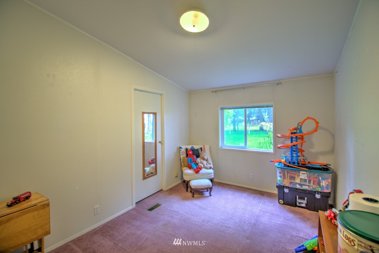 18101 Canaday Lane Southwest Rochester, WA 98579 - Photo 12 of 32 a living room with furniture and a window