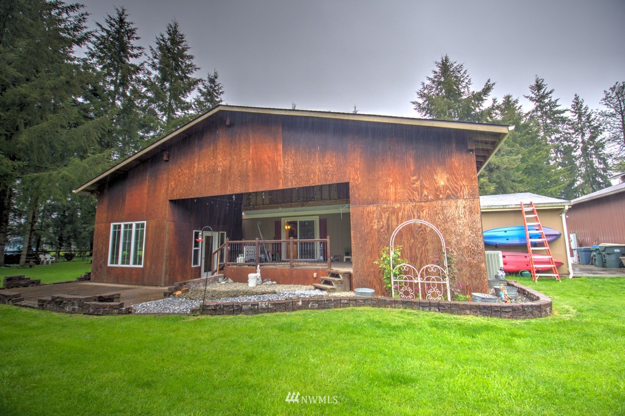 18101 Canaday Lane Southwest Rochester, WA 98579 - Photo 14 of 32 a front view of house with backyard and outdoor seating