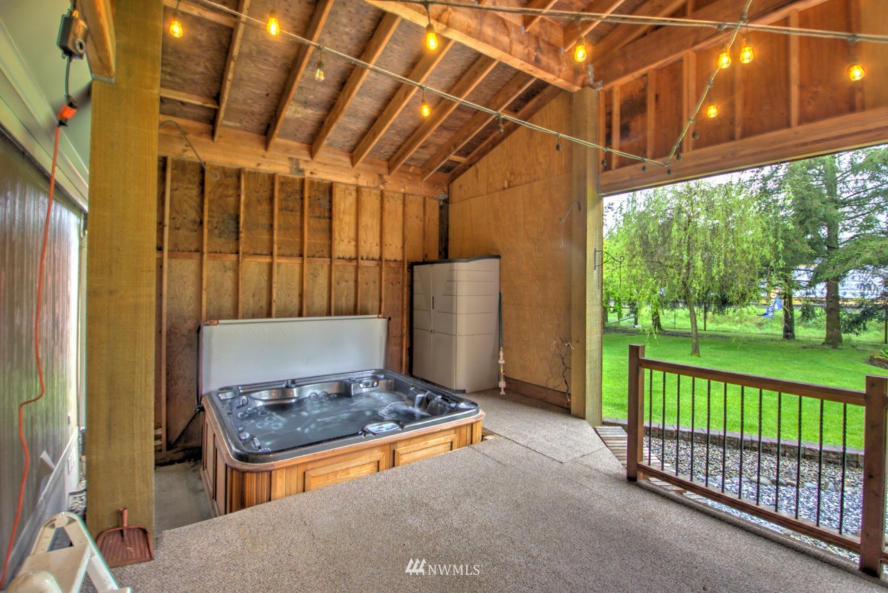 18101 Canaday Lane Southwest Rochester, WA 98579 - Photo 15 of 32 a view of a porch with a floor to ceiling window and wooden fence