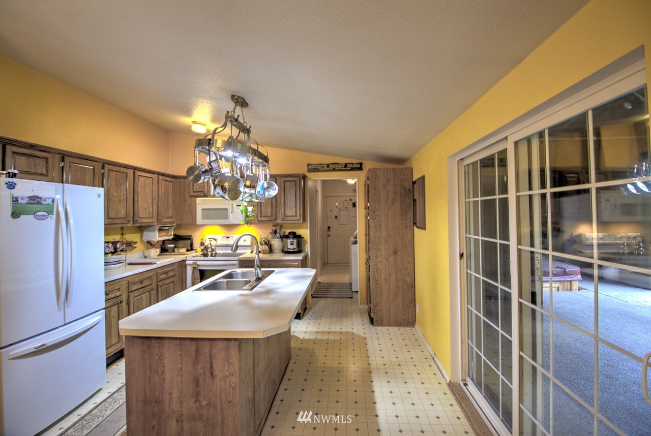 18101 Canaday Lane Southwest Rochester, WA 98579 - Photo 3 of 32 a kitchen with counter top space and refrigerator