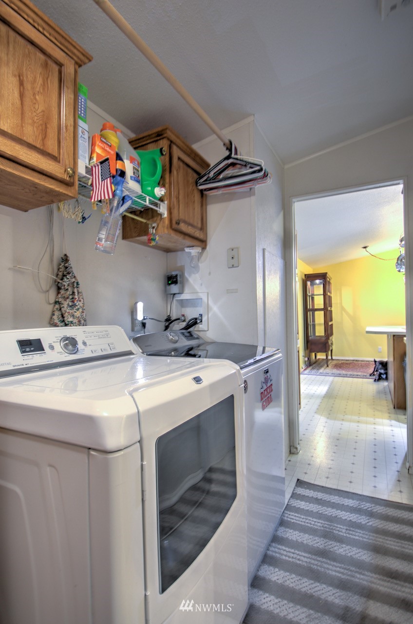 18101 Canaday Lane Southwest Rochester, WA 98579 - Photo 6 of 32 a utility room with cabinets washer and dryer
