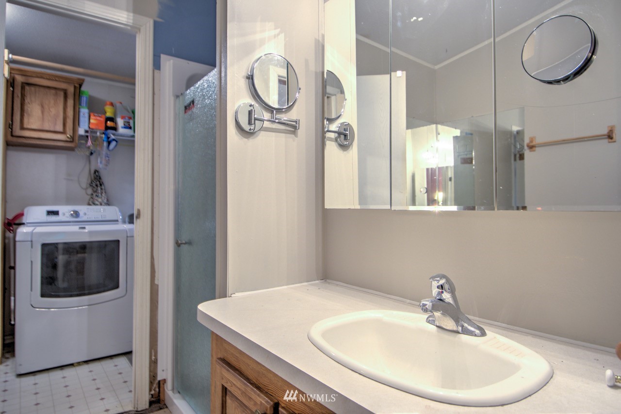 18101 Canaday Lane Southwest Rochester, WA 98579 - Photo 10 of 32 a bathroom with a sink vanity and mirror