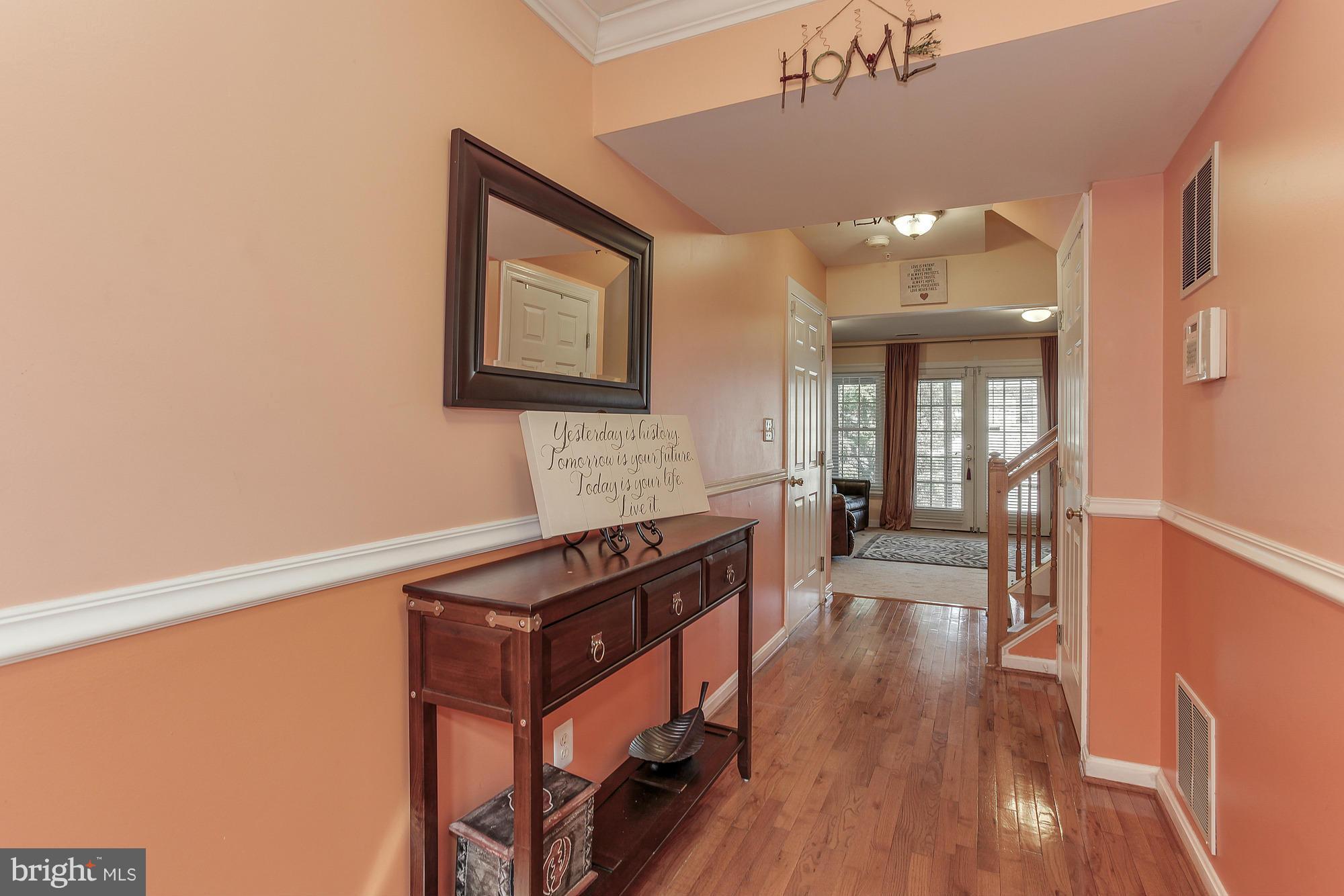 3504 Hammerstone Road Laurel, MD 20724 - Photo 2 of 30 a view of a hallway with wooden floor and staircase