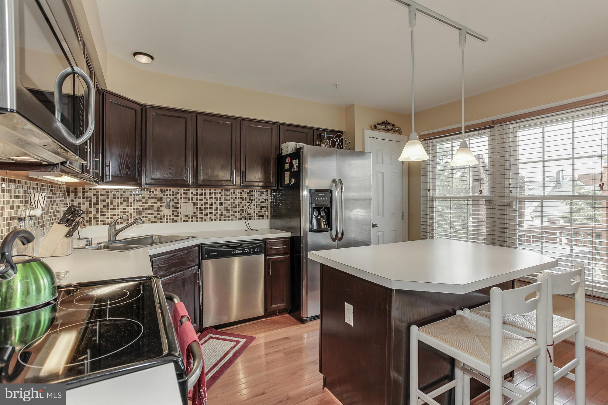 3504 Hammerstone Road Laurel, MD 20724 - Photo 13 of 30 a kitchen with a stove a sink and a refrigerator