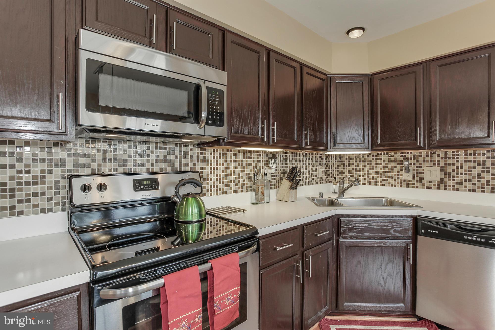 3504 Hammerstone Road Laurel, MD 20724 - Photo 14 of 30 a kitchen with stainless steel appliances a stove sink and cabinets