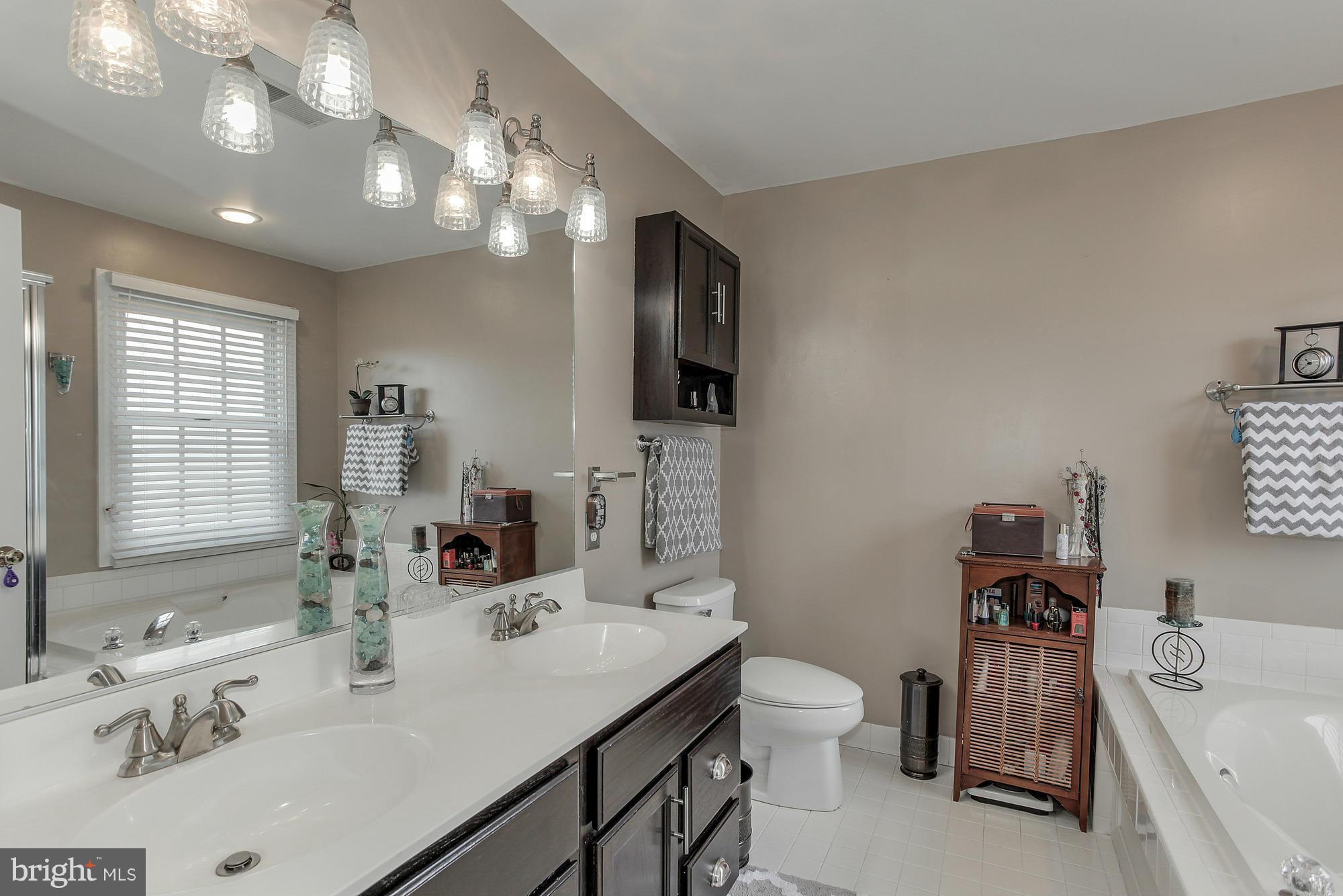 3504 Hammerstone Road Laurel, MD 20724 - Photo 16 of 30 a bathroom with a sink double vanity granite and a toilet