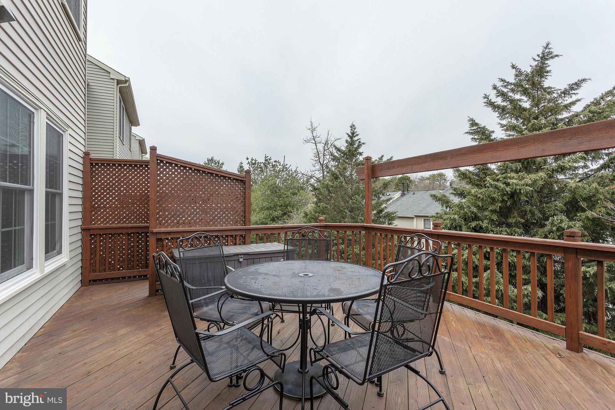 3504 Hammerstone Road Laurel, MD 20724 - Photo 24 of 30 a balcony with wooden floor table and chairs