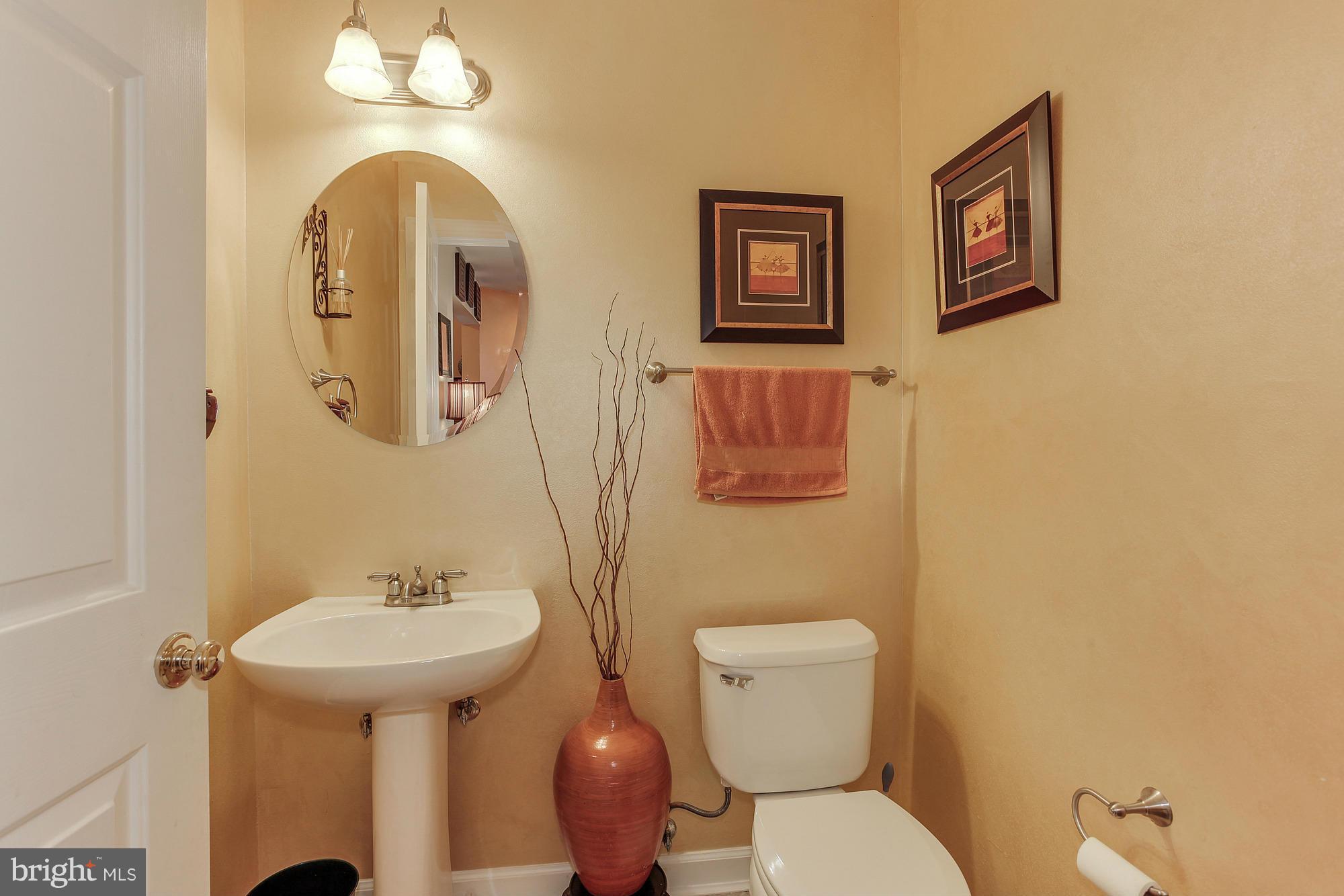 3504 Hammerstone Road Laurel, MD 20724 - Photo 8 of 30 a bathroom with a toilet sink and mirror