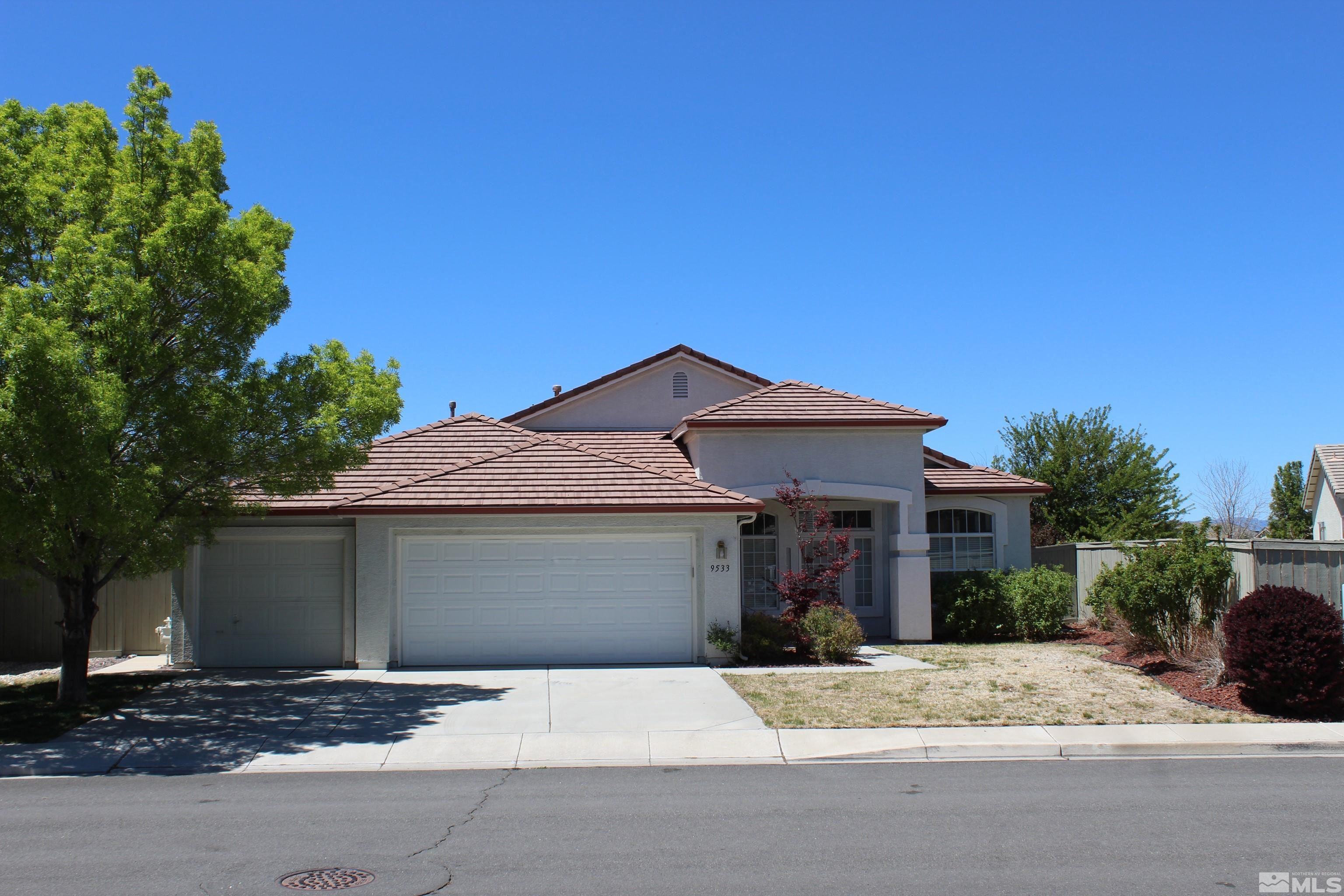9533 Steep Climb Court Reno, NV 89521 - Photo 1 of 15 a front view of a house with a yard and garage