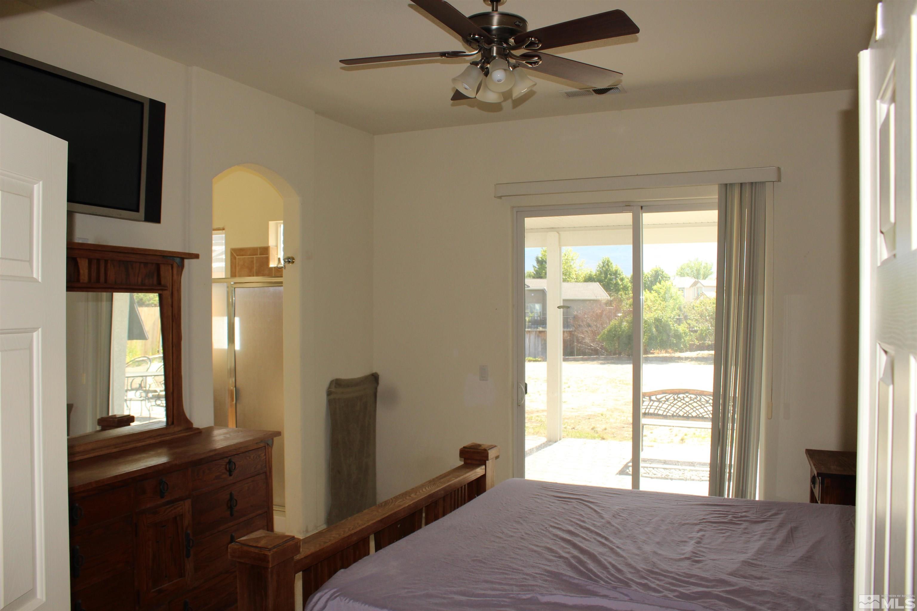 9533 Steep Climb Court Reno, NV 89521 - Photo 15 of 15 a bedroom with a bed and a window