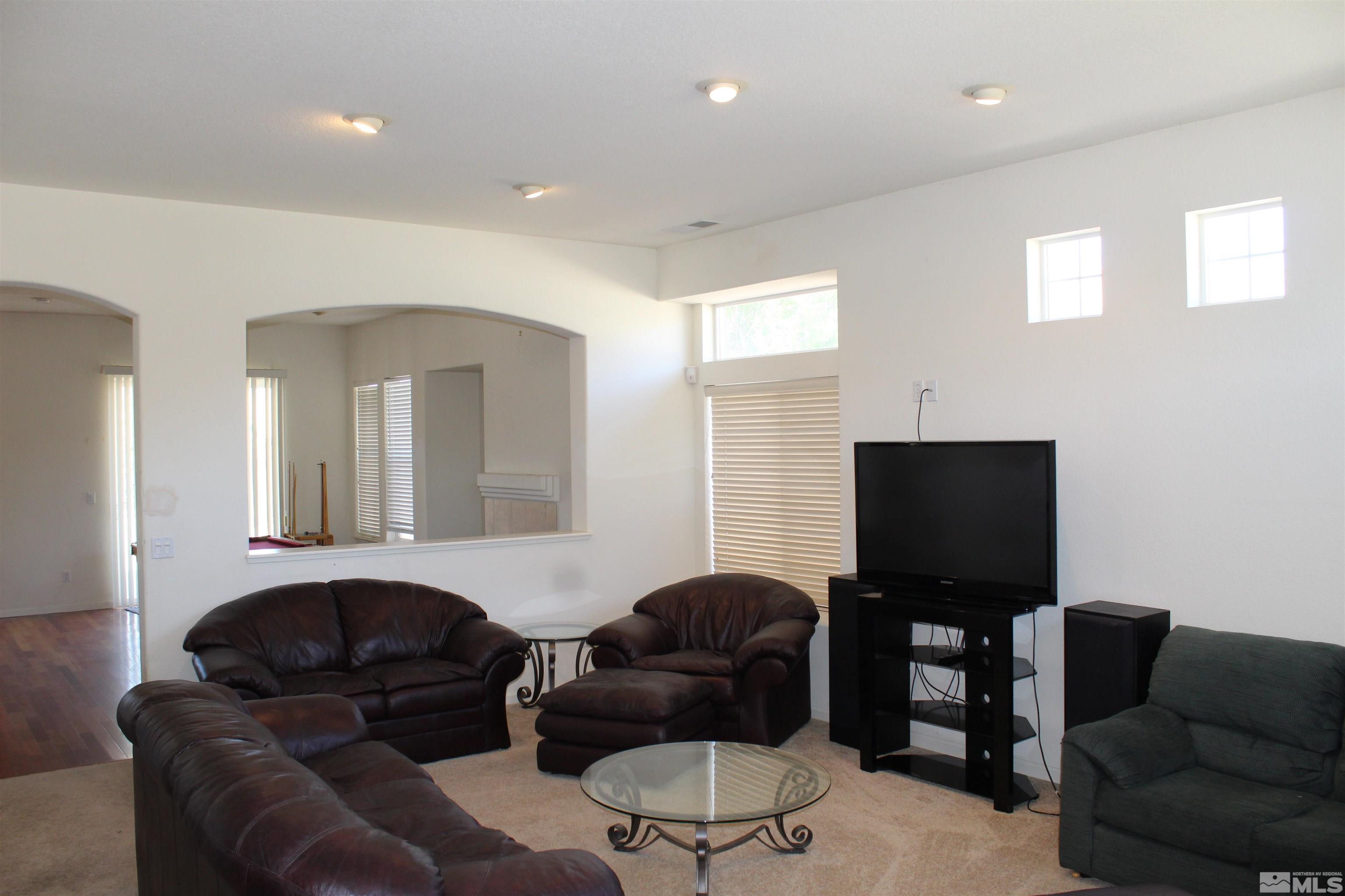9533 Steep Climb Court Reno, NV 89521 - Photo 3 of 15 a living room with furniture and a flat screen tv