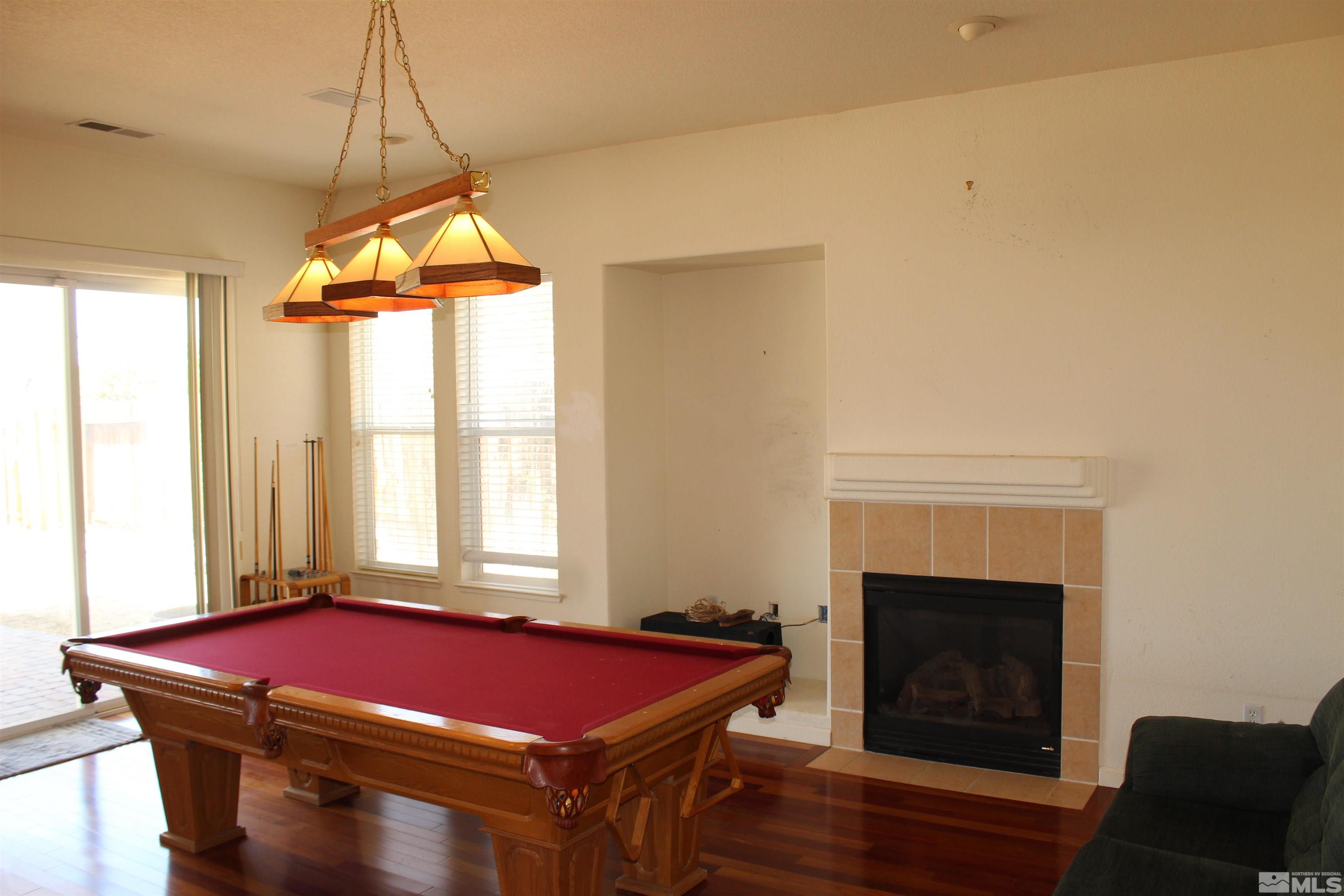 9533 Steep Climb Court Reno, NV 89521 - Photo 5 of 15 a patio with a fireplace and a table