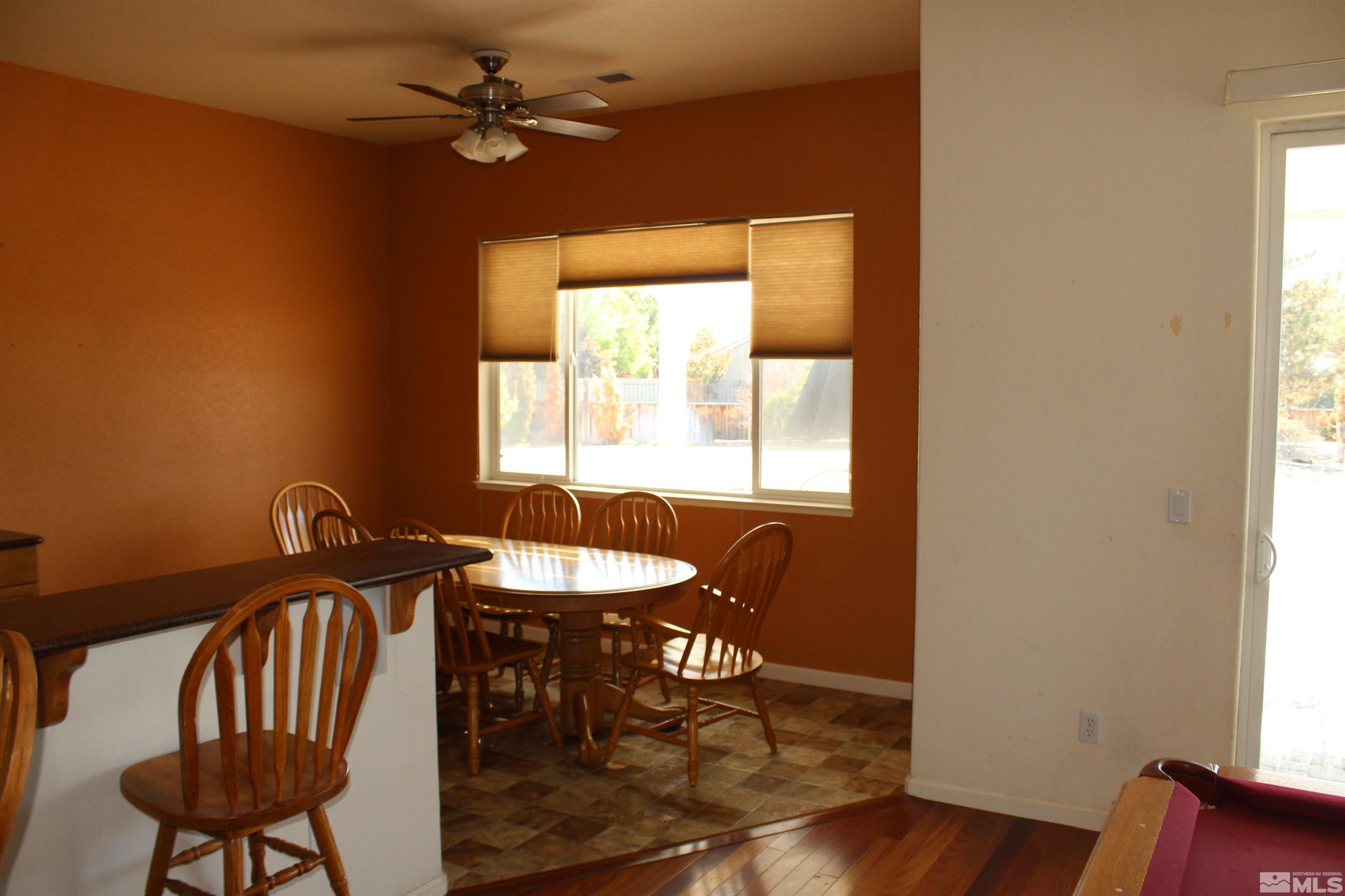 9533 Steep Climb Court Reno, NV 89521 - Photo 8 of 15 a view of a a dining room with furniture window and wooden floor