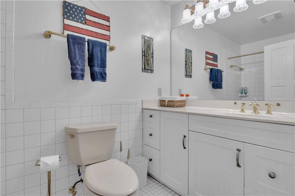 14501 Woolsey Road Hampton, GA 30228 - Photo 106 of 143 a bathroom with a toilet sink and mirror