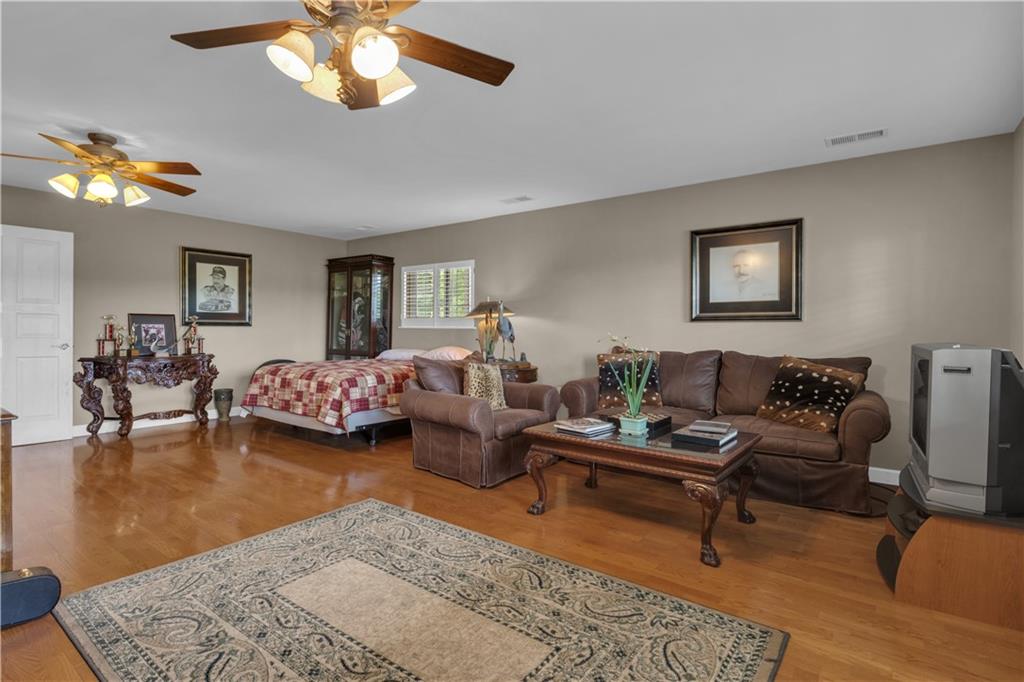 14501 Woolsey Road Hampton, GA 30228 - Photo 109 of 143 a living room with furniture and a chandelier