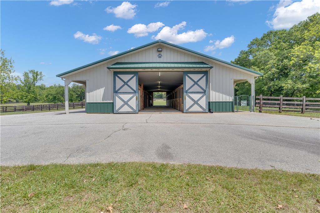 14501 Woolsey Road Hampton, GA 30228 - Photo 122 of 143 a front view of a house with a yard and garage