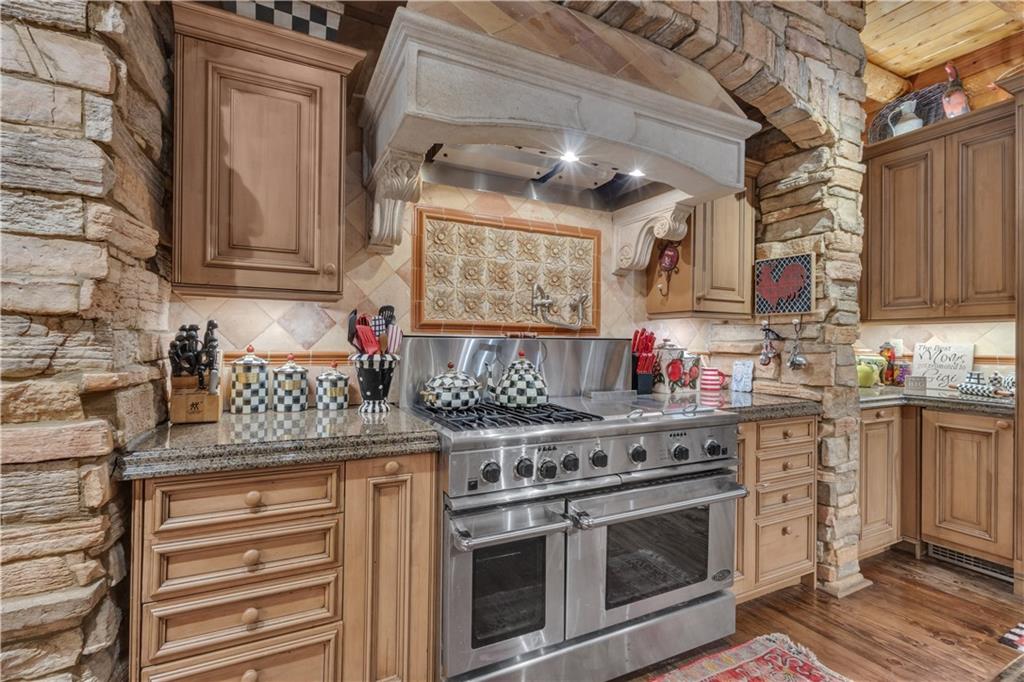 14501 Woolsey Road Hampton, GA 30228 - Photo 30 of 143 a kitchen with stainless steel appliances granite countertop a stove and a sink