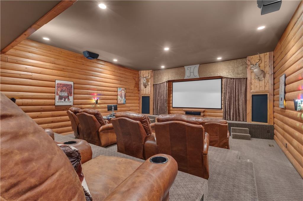 14501 Woolsey Road Hampton, GA 30228 - Photo 33 of 143 a media room with lots of chairs and a projector screen