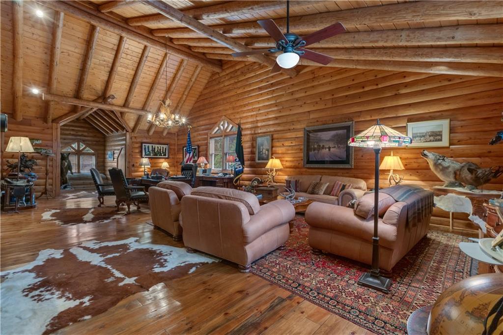 14501 Woolsey Road Hampton, GA 30228 - Photo 51 of 143 a living room with furniture a ceiling fan and a rug