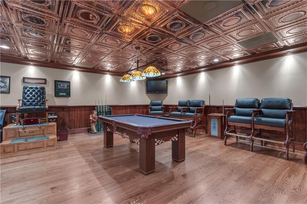 14501 Woolsey Road Hampton, GA 30228 - Photo 65 of 143 a room with furniture gym equipment wooden floor and a rug