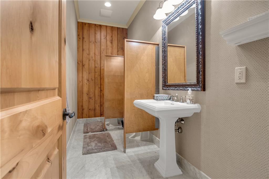 14501 Woolsey Road Hampton, GA 30228 - Photo 83 of 143 a bathroom with a sink a mirror and a bathtub