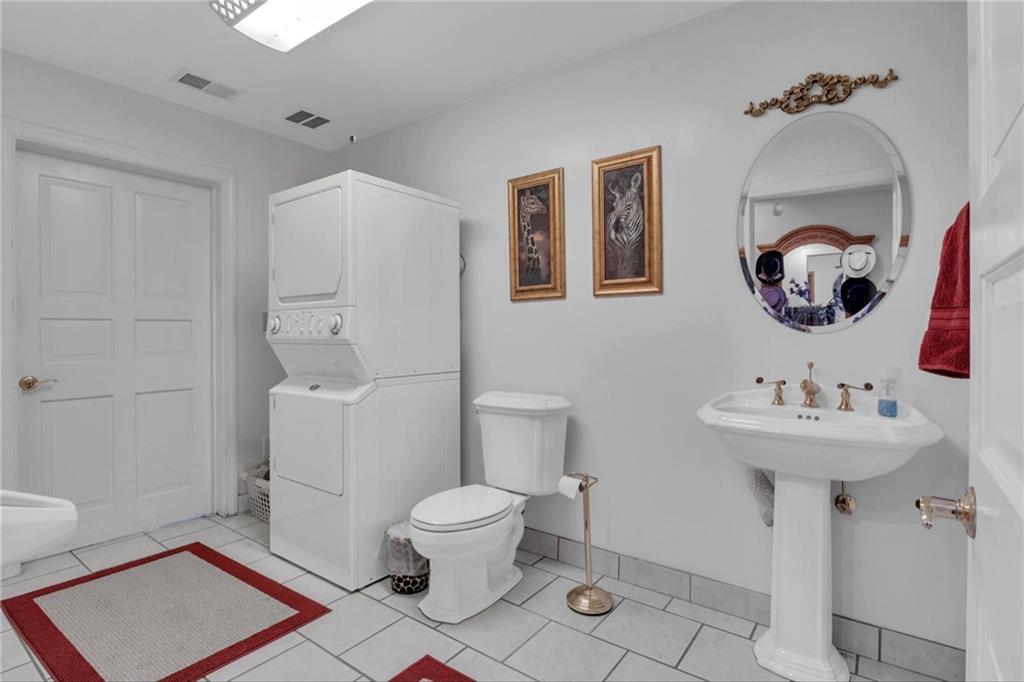 14501 Woolsey Road Hampton, GA 30228 - Photo 100 of 143 a bathroom with a sink mirror and toilet