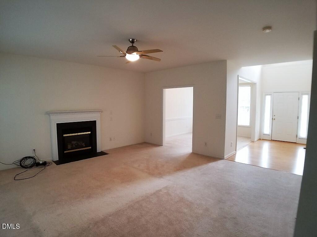 2100 Ramsgate Street Raleigh, NC 27603 - Photo 2 of 13 an empty room with chandelier fan and windows