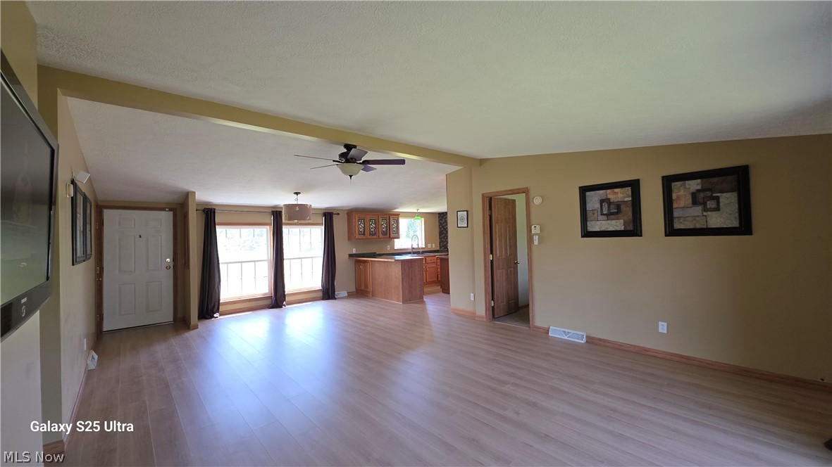 294 Twp 150 Road Sullivan, OH 44880 - Photo 21 of 39 Spacious interior featuring wood-finish flooring, a ceiling fan, and large windows with natural light