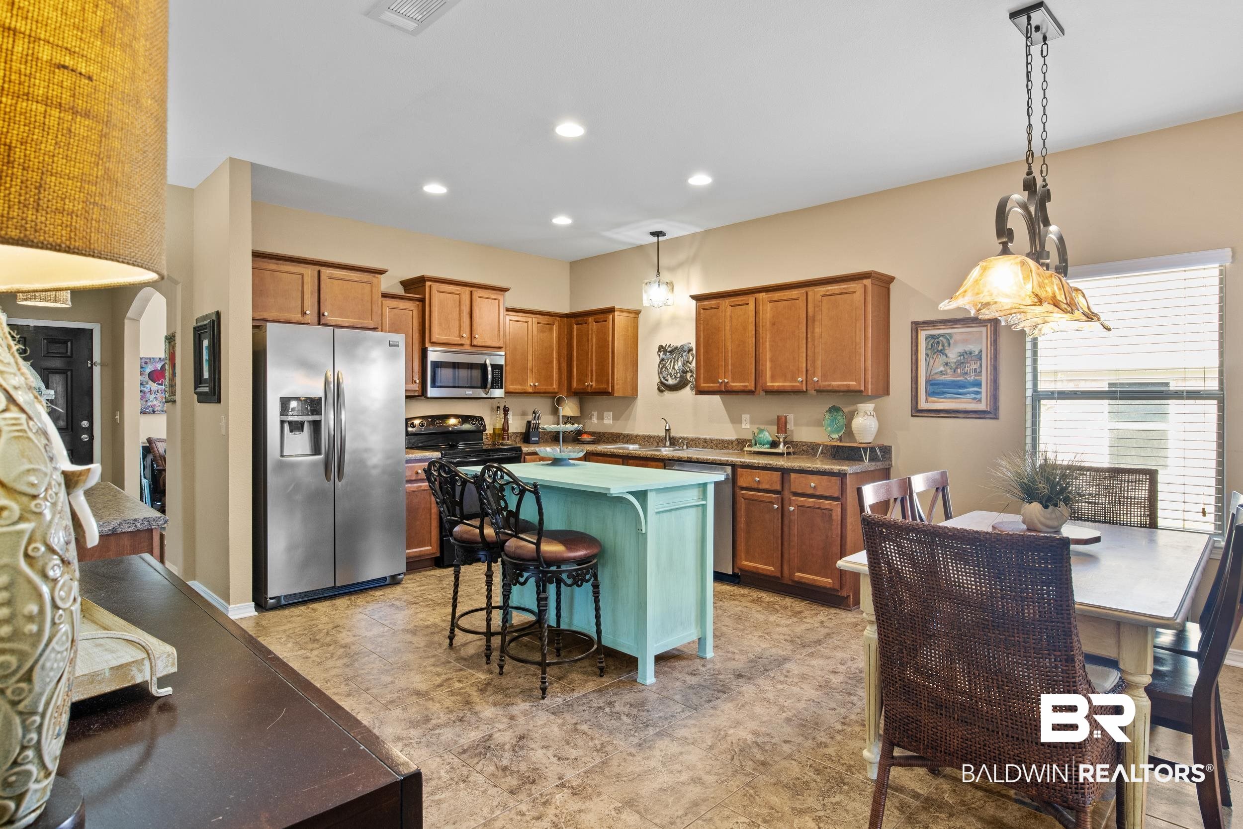 1752 Abbey Loop Foley, AL 36535 - Photo 6 of 21 Kitchen featuring a kitchen bar, a center island, decorative light fixtures, and appliances with stainless steel finishes