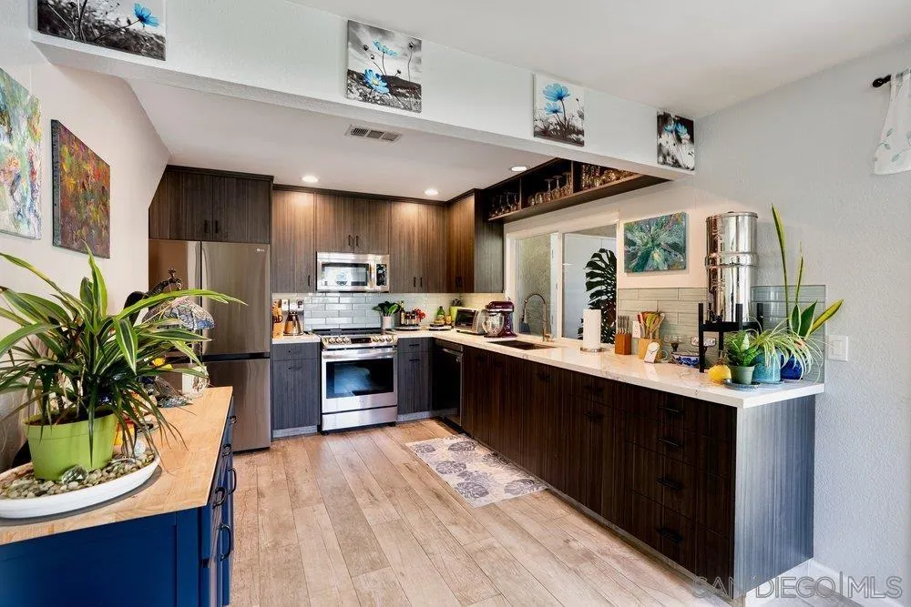 13358 Birch Tree Lane Poway, CA 92064 - Photo 5 of 16 a kitchen with a sink stove and cabinets