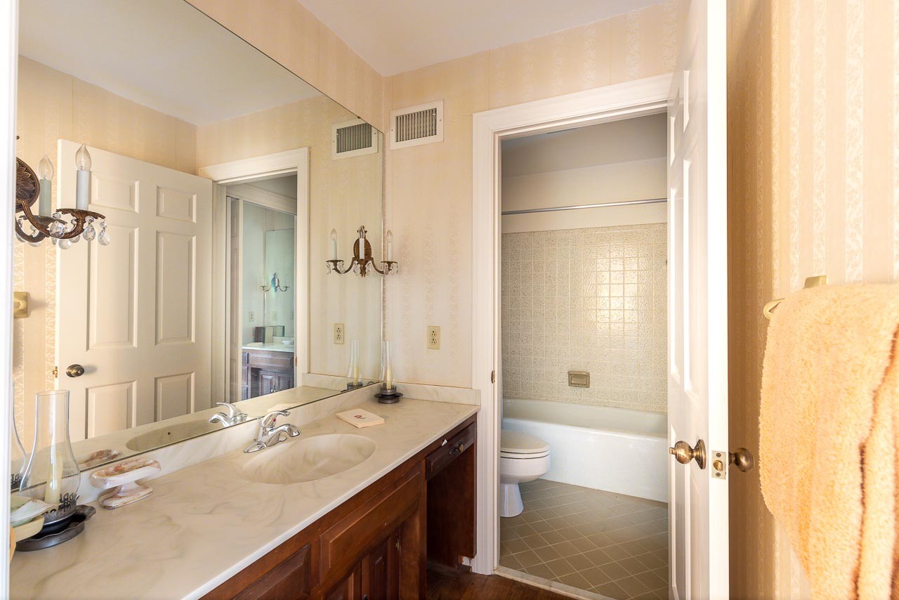 4832 Murfreesboro Road Arrington, TN 37014 - Photo 28 of 70 a bathroom with a granite countertop sink a mirror and a shower
