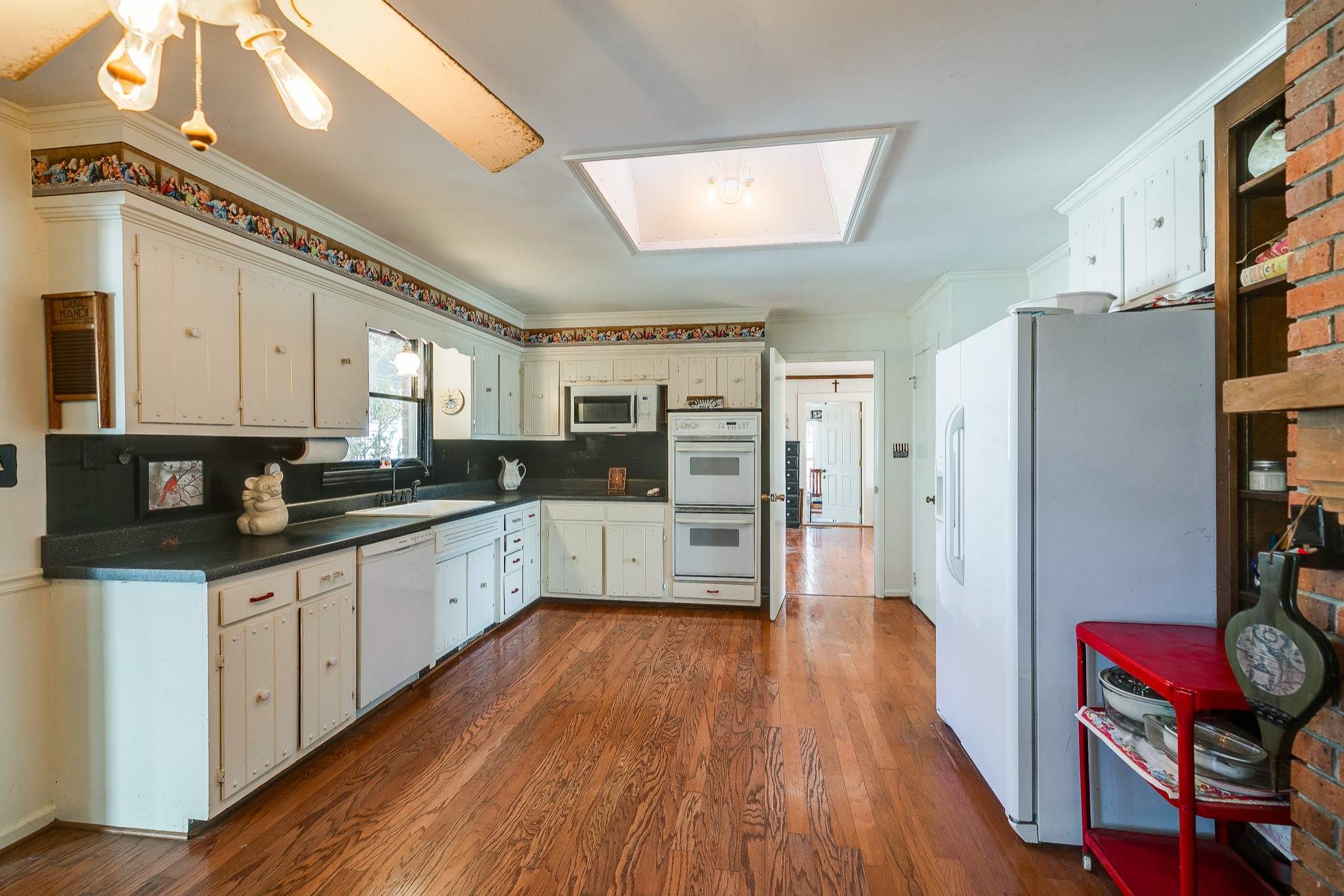 4832 Murfreesboro Road Arrington, TN 37014 - Photo 53 of 70 a large kitchen with stainless steel appliances refrigerator a stove and wooden floors