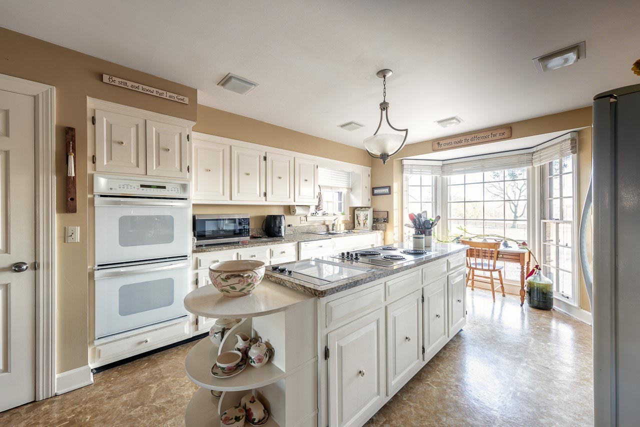 4832 Murfreesboro Road Arrington, TN 37014 - Photo 9 of 70 a kitchen with a stove a sink dishwasher a refrigerator and white cabinets with wooden floor