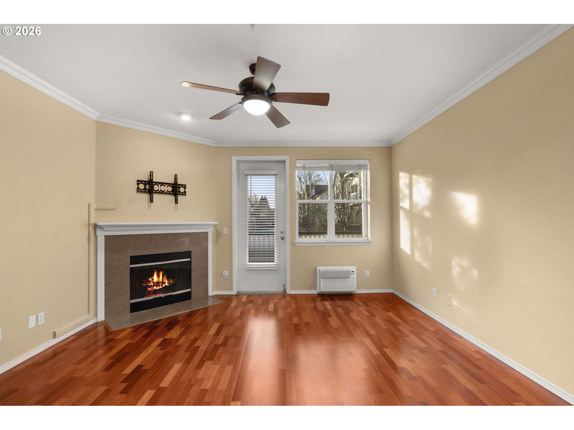 1814 Southeast Cutter Lane Vancouver, WA 98661 - Photo 6 of 40 a view of an empty room with wooden floor fireplace and a window